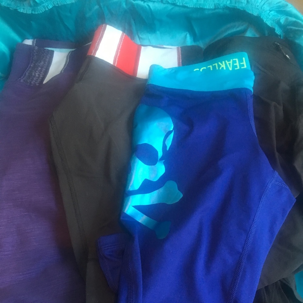 Group of four colorful leggings and workout gear